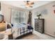 Sports-themed bedroom with a full bed, natural light, and a full-sized basketball player decoration at 8010 Raspberry Dr, Frederick, CO 80504