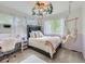Cozy bedroom features a comfortable bed, hanging chair, and bright windows, creating a peaceful and inviting space at 8010 Raspberry Dr, Frederick, CO 80504