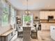 Bright breakfast nook with a round table, chairs, and a window with natural light adjacent to the kitchen at 8010 Raspberry Dr, Frederick, CO 80504