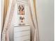 Elegant closet nook with a decorative chest of drawers, tasteful artwork, and flowing, accented curtains at 8010 Raspberry Dr, Frederick, CO 80504