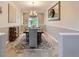 A beautifully decorated dining room featuring an elegant chandelier, area rug and views of the outdoors at 8010 Raspberry Dr, Frederick, CO 80504