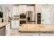 Kitchen featuring a stainless steel refrigerator, double oven, white cabinets, and a pantry at 8010 Raspberry Dr, Frederick, CO 80504