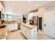 Open floor plan with a modern kitchen featuring a center island, stainless steel appliances, and seamless flow to living area at 8010 Raspberry Dr, Frederick, CO 80504