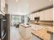 An open kitchen with a kitchen island and stainless steel appliances and breakfast nook with lots of natural light at 8010 Raspberry Dr, Frederick, CO 80504