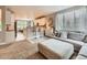 Open floorplan showcasing a sunlit living room and a modern kitchen with a breakfast bar and seating at 8010 Raspberry Dr, Frederick, CO 80504