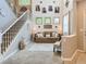 Elegant living room featuring a soaring staircase, a comfortable sofa, and tasteful decor at 8010 Raspberry Dr, Frederick, CO 80504