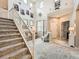 Elegant living room featuring a soaring staircase, comfortable seating, and stylish decor at 8010 Raspberry Dr, Frederick, CO 80504
