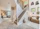 Elegant living room featuring a soaring staircase, a comfortable sofa, and tasteful decor at 8010 Raspberry Dr, Frederick, CO 80504