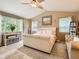 Spacious main bedroom with a stylish tufted bed, cozy seating area, and sun-filled windows at 8010 Raspberry Dr, Frederick, CO 80504