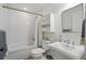 Bright bathroom featuring a tub-shower, a vanity with storage, and coordinated fixtures at 201 S Lafayette St, Denver, CO 80209