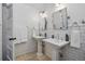 Elegant bathroom featuring dual pedestal sinks, subway tile walls, and decorative mirrors at 201 S Lafayette St, Denver, CO 80209