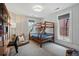 Charming bedroom with wood bunk beds, decorative pillows, stylish wallpaper, and a cozy seating area at 201 S Lafayette St, Denver, CO 80209