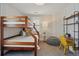 Stylized bedroom featuring wood bunk beds, striped wallpaper, ample lighting, and stylish furniture at 201 S Lafayette St, Denver, CO 80209