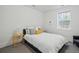 Bright bedroom with neutral bedding, stylish side tables, and a sunny window at 201 S Lafayette St, Denver, CO 80209