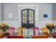 Elegant dining room featuring glass table, colorful chairs, and black double doors at 201 S Lafayette St, Denver, CO 80209