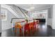 Bright dining room with glass table, colorful chairs, and open floor plan leading to a modern kitchen at 201 S Lafayette St, Denver, CO 80209