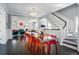 Bright dining area with a glass-top table, colorful chairs, and a clear view to the living room at 201 S Lafayette St, Denver, CO 80209