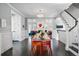 Elegant dining room with a long table, stylish chairs, and an open view to the living room at 201 S Lafayette St, Denver, CO 80209