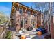 Exterior view featuring a brick home with a patio seating area, grill, and manicured lawn at 201 S Lafayette St, Denver, CO 80209