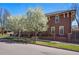 Charming home with manicured lawn, blossoming trees, and a welcoming facade at 201 S Lafayette St, Denver, CO 80209