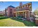 Exterior view featuring a brick home with a manicured lawn and a view of the front entrance at 201 S Lafayette St, Denver, CO 80209