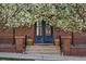 Inviting front entrance with double doors, brick pillars, and potted plants at 201 S Lafayette St, Denver, CO 80209
