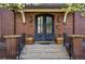 Close-up of the front door with brick accents, potted plants, and a welcoming ambiance at 201 S Lafayette St, Denver, CO 80209