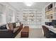 Cozy home office and den features a leather sofa, bookcase, and natural light at 201 S Lafayette St, Denver, CO 80209