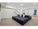 Spacious living room with comfortable modular seating, stairs to another floor, and ample natural light at 201 S Lafayette St, Denver, CO 80209