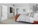 Bright main bedroom with neutral carpet, white walls, wood accents and large art pieces at 201 S Lafayette St, Denver, CO 80209
