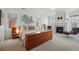 A serene main bedroom features a fireplace, a unique headboard, and a sitting area for relaxing and unwinding at 201 S Lafayette St, Denver, CO 80209