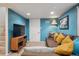 Finished basement featuring comfortable seating, modern entertainment center, and bright blue walls at 3130 N Race St, Denver, CO 80205