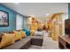 Finished basement featuring wood paneled walls with built-in bookshelves and a comfortable seating area at 3130 N Race St, Denver, CO 80205