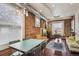 Dining area with vintage table, chairs, and exposed brick, perfect for entertaining at 3130 N Race St, Denver, CO 80205