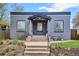 Charming gray brick home with a cozy covered entry and inviting front yard landscaping at 3130 N Race St, Denver, CO 80205