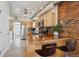 Kitchen featuring stainless steel appliances, brick accent wall, and large center island with seating at 3130 N Race St, Denver, CO 80205