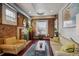 Cozy living room with exposed brick, hardwood floors, and lots of natural light at 3130 N Race St, Denver, CO 80205