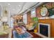 Open-concept living room with exposed brick wall, fireplace, and hardwood floors at 3130 N Race St, Denver, CO 80205