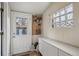 Mud room featuring a glass block window, cabinet storage, and a pegboard wall organizer at 3130 N Race St, Denver, CO 80205