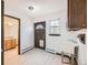 This mudroom features practical tile flooring, a utility sink, and a convenient exterior door with a small window at 2501 S Gray Ct, Lakewood, CO 80227