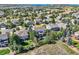 Stunning aerial view of the property showcasing its mature trees, backyard pool area, and neighborhood at 6017 Merchant Pl, Parker, CO 80134