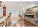 Cozy basement area with a stone fireplace, bar seating, and stylish tile flooring at 6017 Merchant Pl, Parker, CO 80134