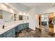 Stylish bathroom includes dual sink vanity, mirror, tiled floors, and a large walk-in closet at 6017 Merchant Pl, Parker, CO 80134
