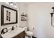 Elegant powder room with a white vanity and decorative mirror at 6017 Merchant Pl, Parker, CO 80134