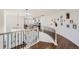 Elegant foyer with hardwood floors, wrought iron railings, and a view of the living area at 6017 Merchant Pl, Parker, CO 80134