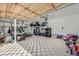 Spacious garage with high ceilings, overhead storage, and diamond pattern flooring, perfect for storage at 6017 Merchant Pl, Parker, CO 80134