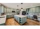 Modern kitchen with green cabinets, quartz countertops, and an island at 6017 Merchant Pl, Parker, CO 80134