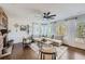Sun-drenched living room with a cozy seating area and hardwood floors at 6017 Merchant Pl, Parker, CO 80134