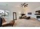 The primary bedroom includes a fireplace, ceiling fan, and relaxing chaise lounge at 6017 Merchant Pl, Parker, CO 80134