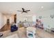 Open playroom with a ceiling fan and a view of the foyer with stone and wood finishes at 6017 Merchant Pl, Parker, CO 80134